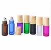 /product-detail/5ml-frosted-matte-white-black-amber-blue-green-purple-pink-roll-on-glass-bottle-with-wood-grain-cap-perfume-essential-oil-bottle-62385970268.html