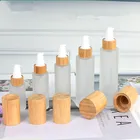 Hot sale silk screen printing colored frosted glass round empty lotion pump bottle with bamboo engraving caps 30ml 50ml 60ml