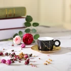 Amber matt black porcelain ware coffee and tea cup with circular handles and aluminium saucer