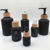 Cosmetic packaging frosted black slant shoulder glass bottle and jar with bamboo lid Factory directly provide