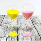 small round glass hourglass sand timer with silver sand