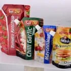 Customized liquid water milk juice oil plastic stand up packaging bag corner spout bag with cap