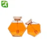 /product-detail/wholesale-empty-100ml-200ml-250ml-380ml-hexagon-food-grade-glass-honey-pot-jar-with-wooden-bamboo-lid-62054700520.html
