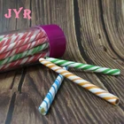 white and orange stripe stick candy in Transparent cup