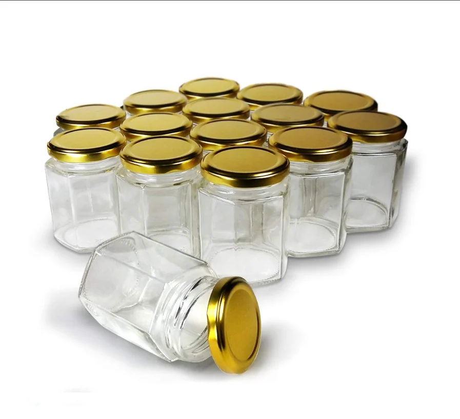 En gros vide petit pot de stockage de nourriture en verre bouteilles de miel hexagone pot de miel ours bouteille bocal en verre avec couvercle