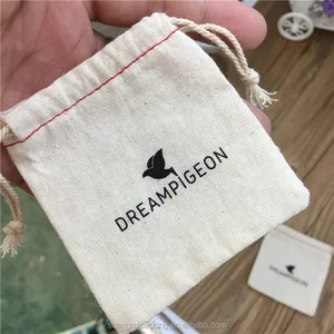 muslin cotton gift bag with red hem and natural drawstring