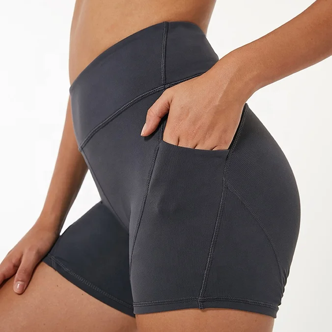 Venta al por mayor logotipo personalizado Fitness botín de cintura alta para mujeres Yoga pantalones cortos con bolsillos