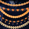 Halloween pumpkin flowers and decorations, skeleton braces, many banners.