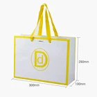 High quality custom logo elegant white and yellow perforated garment kraft paper gift packing bag with custom size