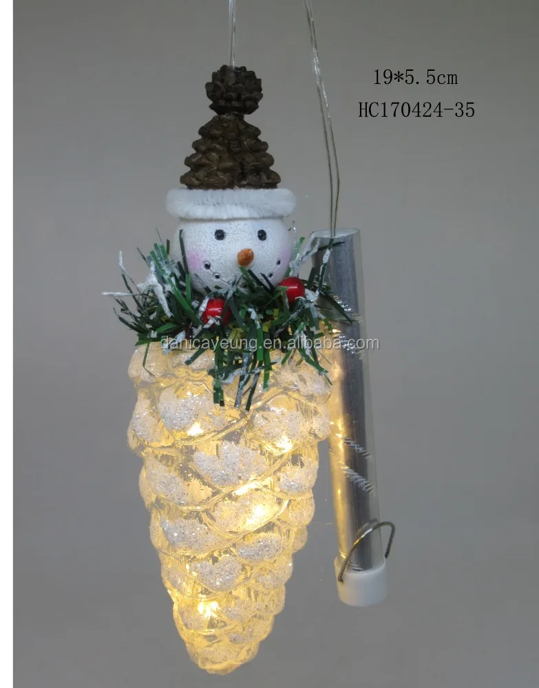 sowman standing on pine cone with led decorations for christmas