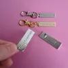 custom made company logo metal handbag tags and zipper pulls