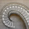 staircase with combines both a helical and spiral form to create an elegant focal point
