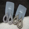silver grey light grey earring card with logo white writing