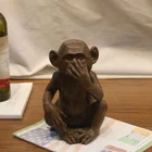 Wholesale animal statues home decor covring the mouth fiberglass monkey resin