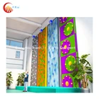 solid indoor climbing wall with different shapes and sizes of rock climbing holds