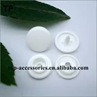 White plastic snap button with four parts for clothing