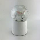 Wholesale white resin craft snow globe with LED light playing snowflake rotation music snow ball souvenir