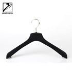 Black flocked plastic hanger with gold hook for coat or dress