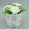 Artificial flower rose arrangement in metallic cement pot