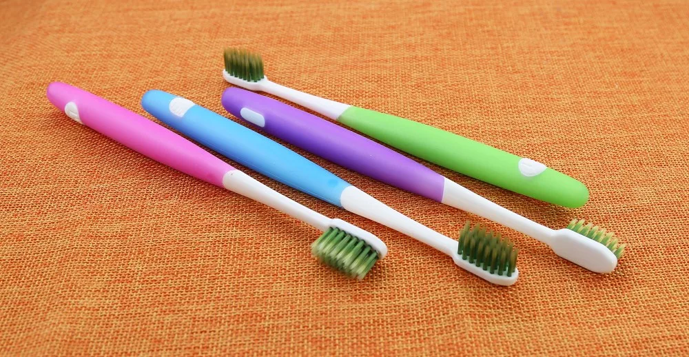 Small Head Toothbrush With 'green Tea' Filament And Soft Rubber Handle