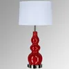 Red ceramic base table lamp with cream white linen fabric shade and AC outlets
