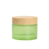 /product-detail/wholesale-green-cream-jar-luxury-glass-cosmetic-jar-with-wood-grain-plastic-lid-60820391094.html