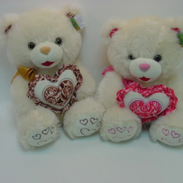 gift dark brown teddy bear in a white t-shirt with printing pink
