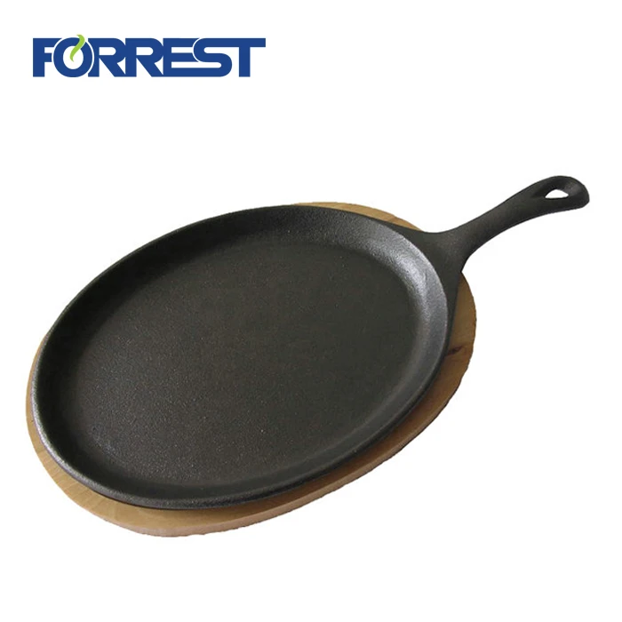 oval cast iron vegetable oil frying pan with wooden base