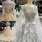 ヴィンテージ O ネックビーズスパンコールのボディス A ラインシルバーゴールド調の結婚式のドレスとケープイスラムブライダルドレス