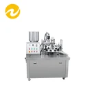 Metal tube filling and sealing machine