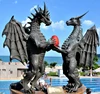 western style life size double winged dragon statue holding a ball