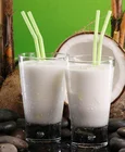 Raw squeezed organic coconut milk juice drink in bottle/tin