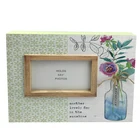 Wooden photo frame with painting tied jute bow hanging metal card sit on bedstand