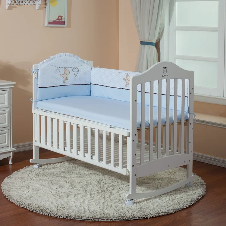 white cot with storage