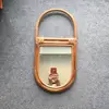/product-detail/brown-lacquer-oval-rattan-vintage-mirror-50039080581.html
