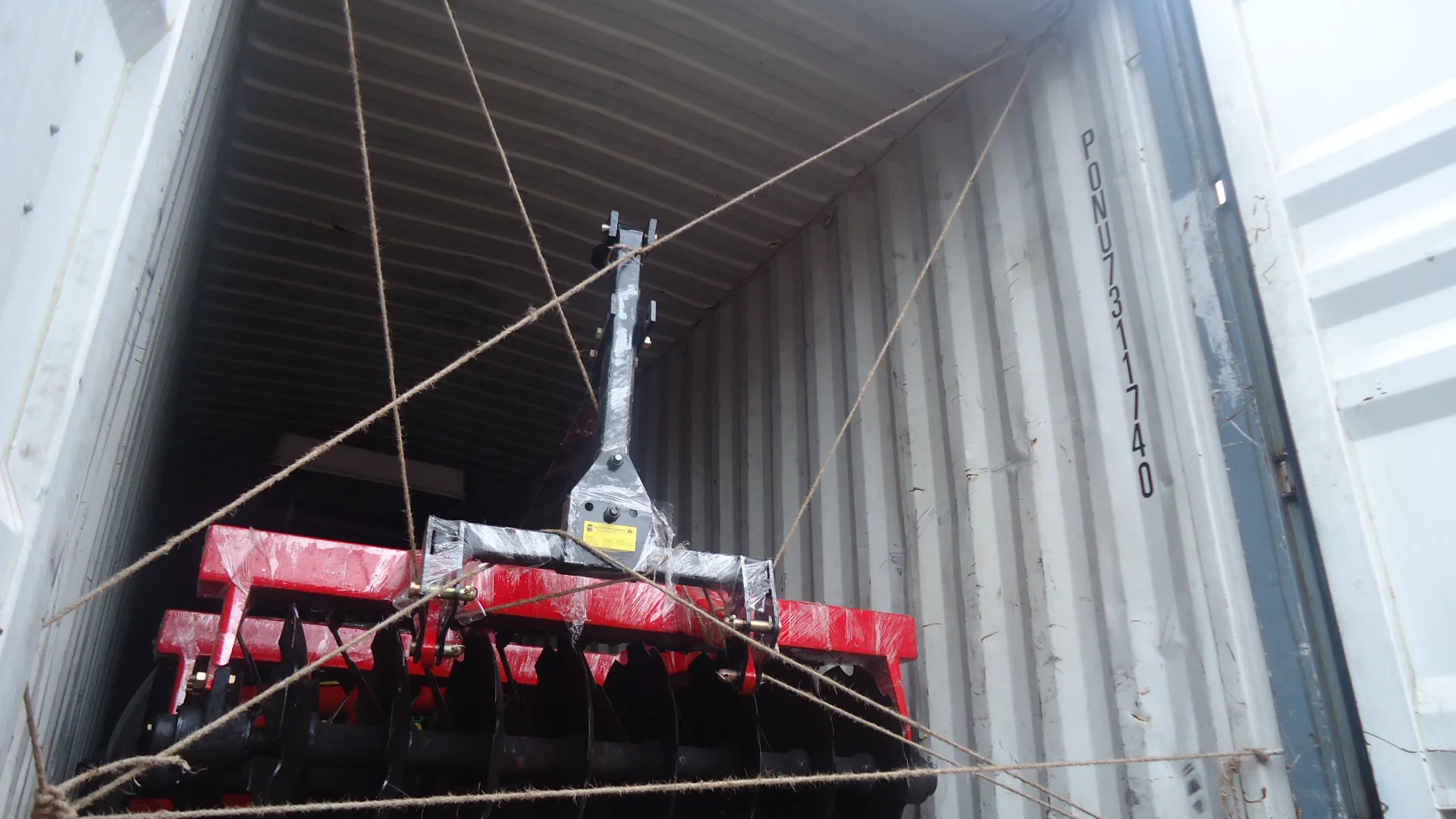 harrow loaded in container