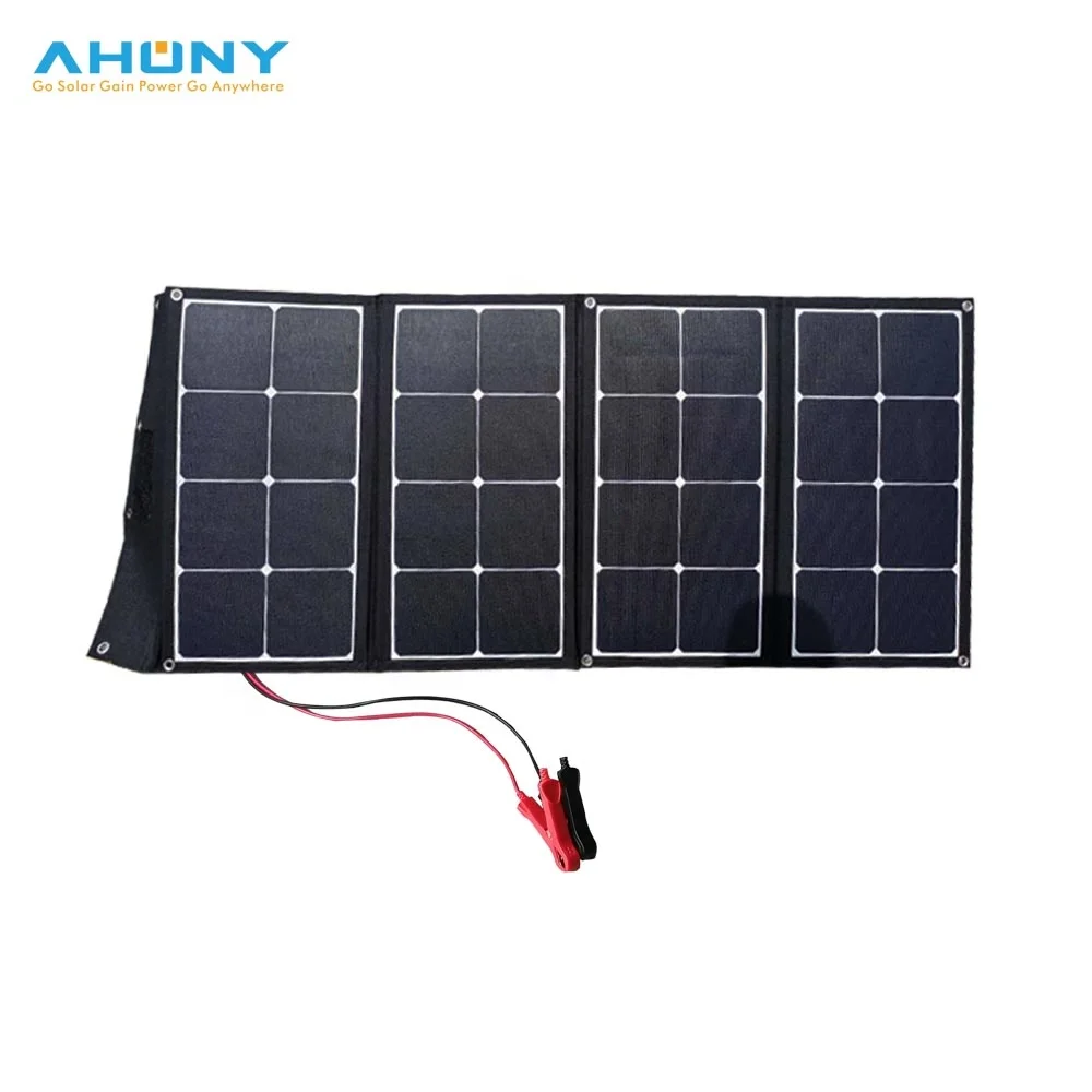 Folding 12V solar suitcase deployed on grass with built-in kickstand and Anderson connector