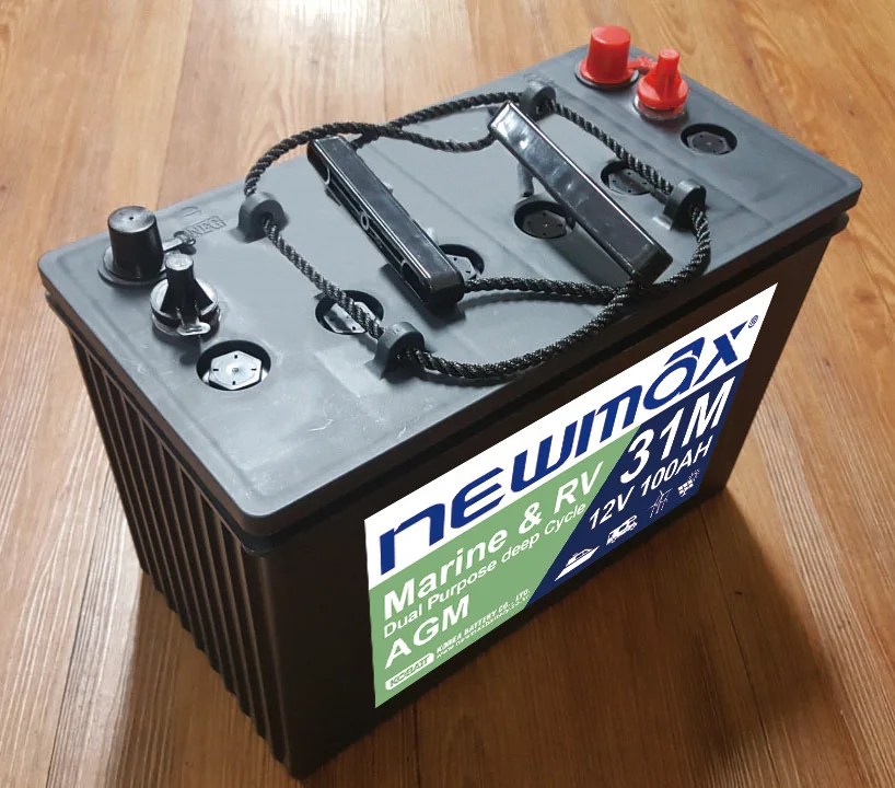 Side-by-side comparison of Odyssey, Optima, and VMAX 12V AGM batteries on workbench