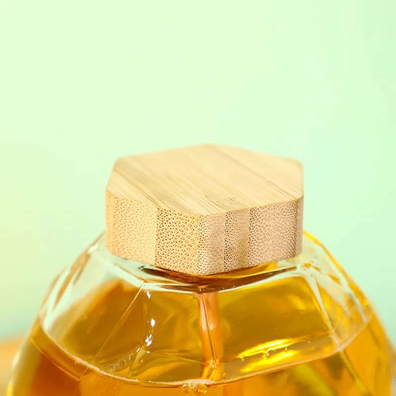 Factory Direct sales Glass Hexagon Honey Bottles Jar With Wooden Dipper And Lid supplier