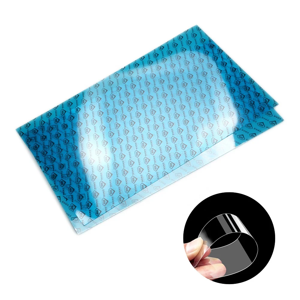 Close-up of unrolled PET screen protector film on a clean workbench with ruler and cutting tool
