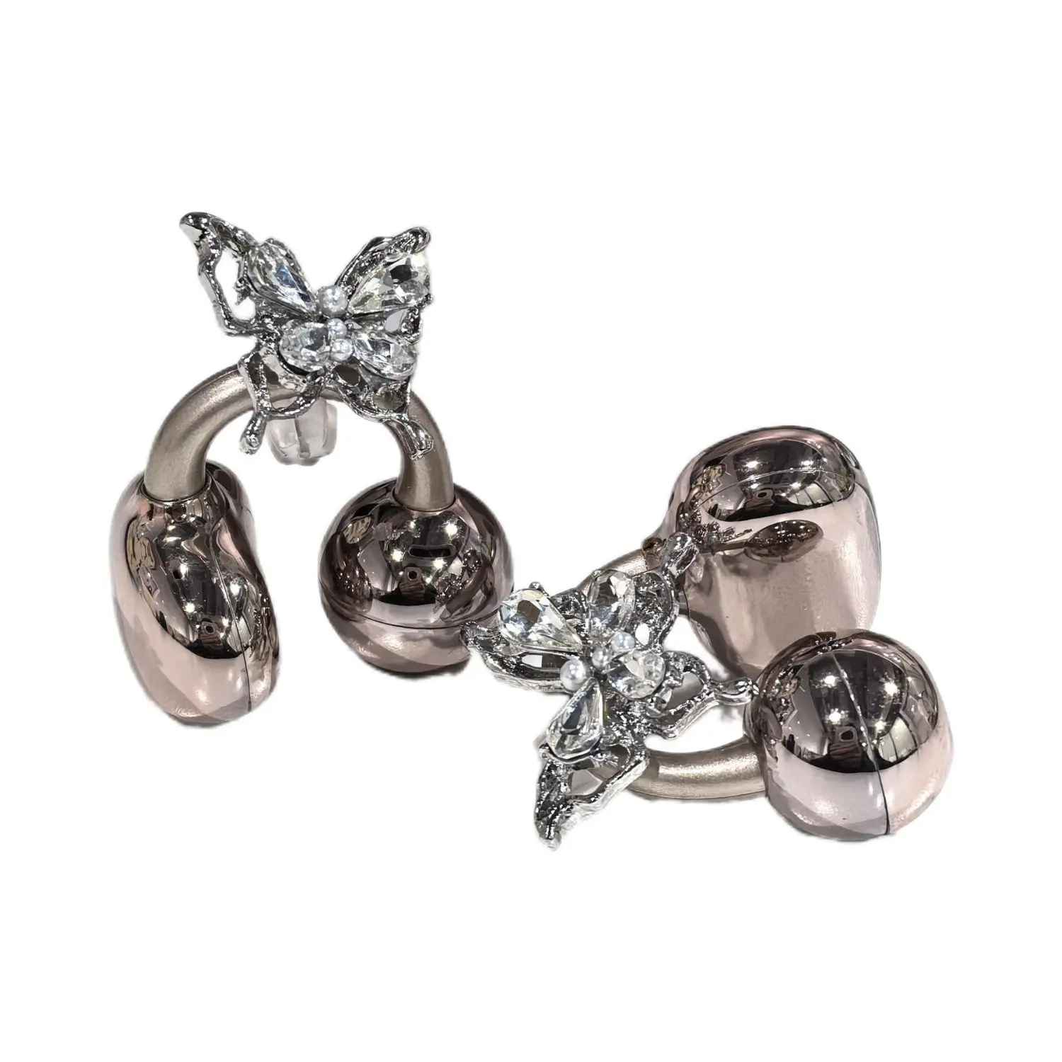 Close-up of butterfly earbud clip mechanism showing spring tension adjustment and silicone grip pad