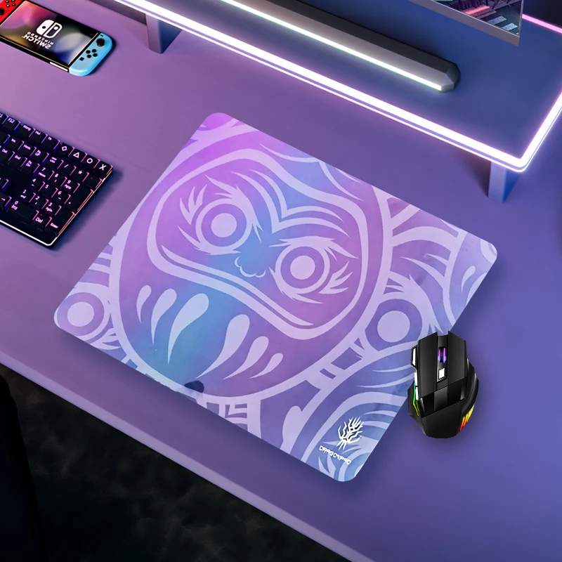 Tempered glass mouse pad on a clean desk with RGB gaming mouse