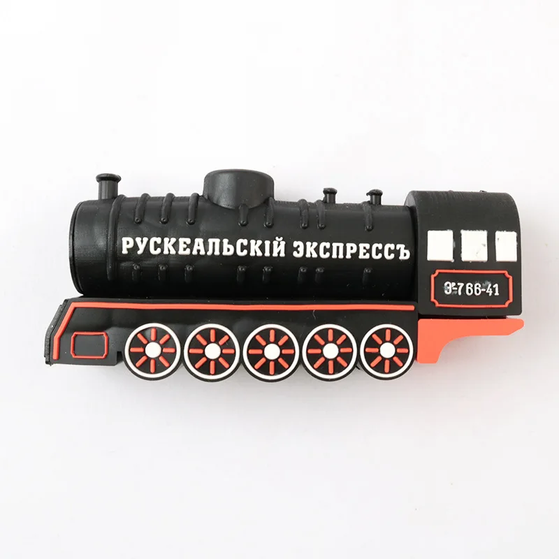 Black steam locomotive shaped USB flash drive on wooden desk with vintage railway ticket