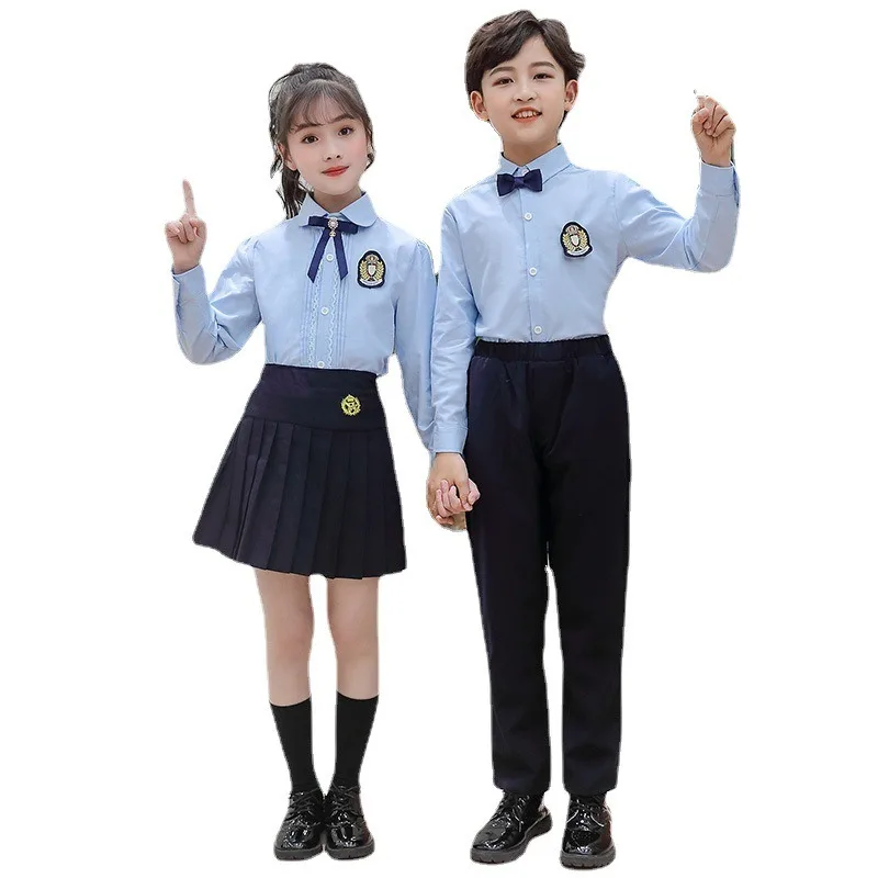 Boy in grey-and-red checked trousers with navy blazer and white shirt