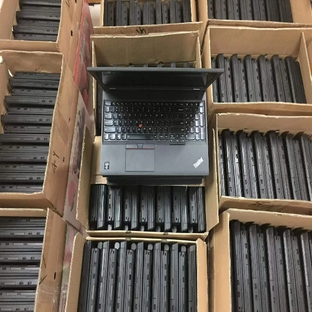 Stack of sealed laptop cartons labeled with HS codes and country-of-origin tags