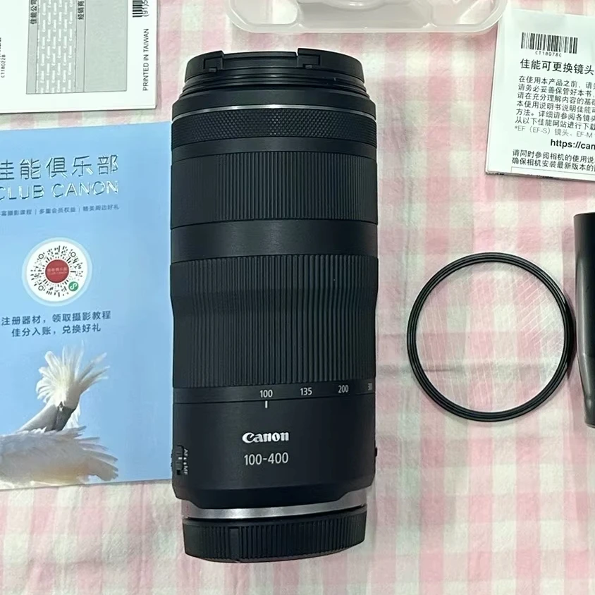 Side-by-side comparison of three 100-400mm lenses showing size and weight differences