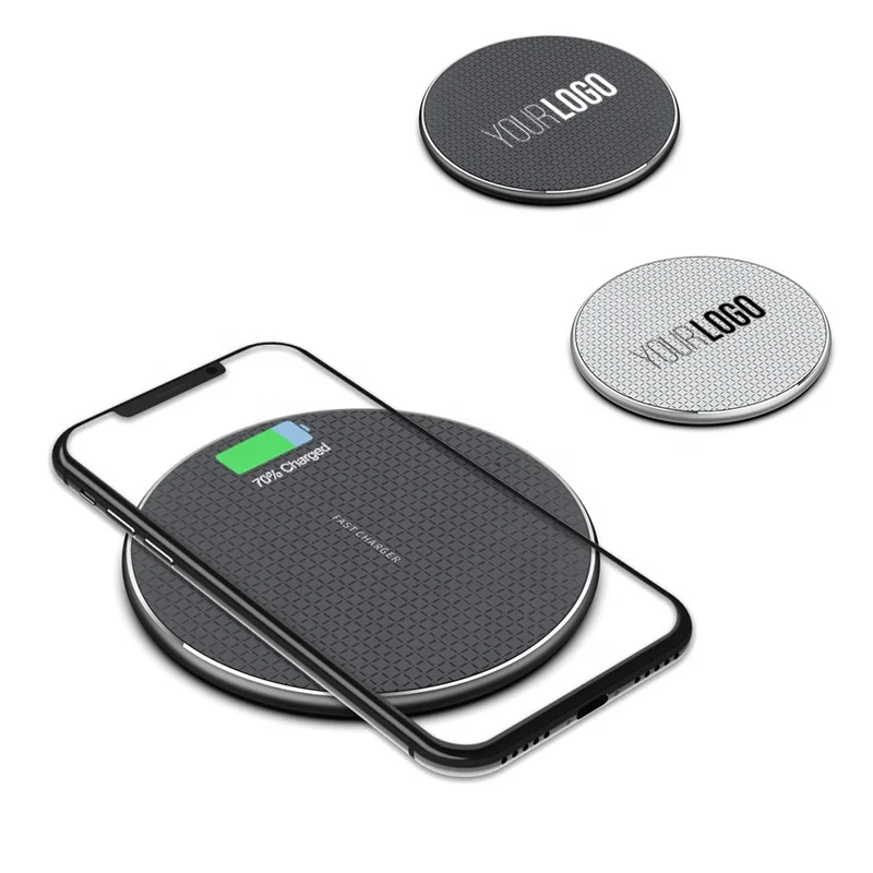Branded Bluetooth tracker attached to keychain next to wallet and smartphone