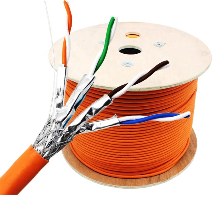 Close-up of shielded twisted pair cable being terminated to a DIN rail terminal block with shield clamped separately