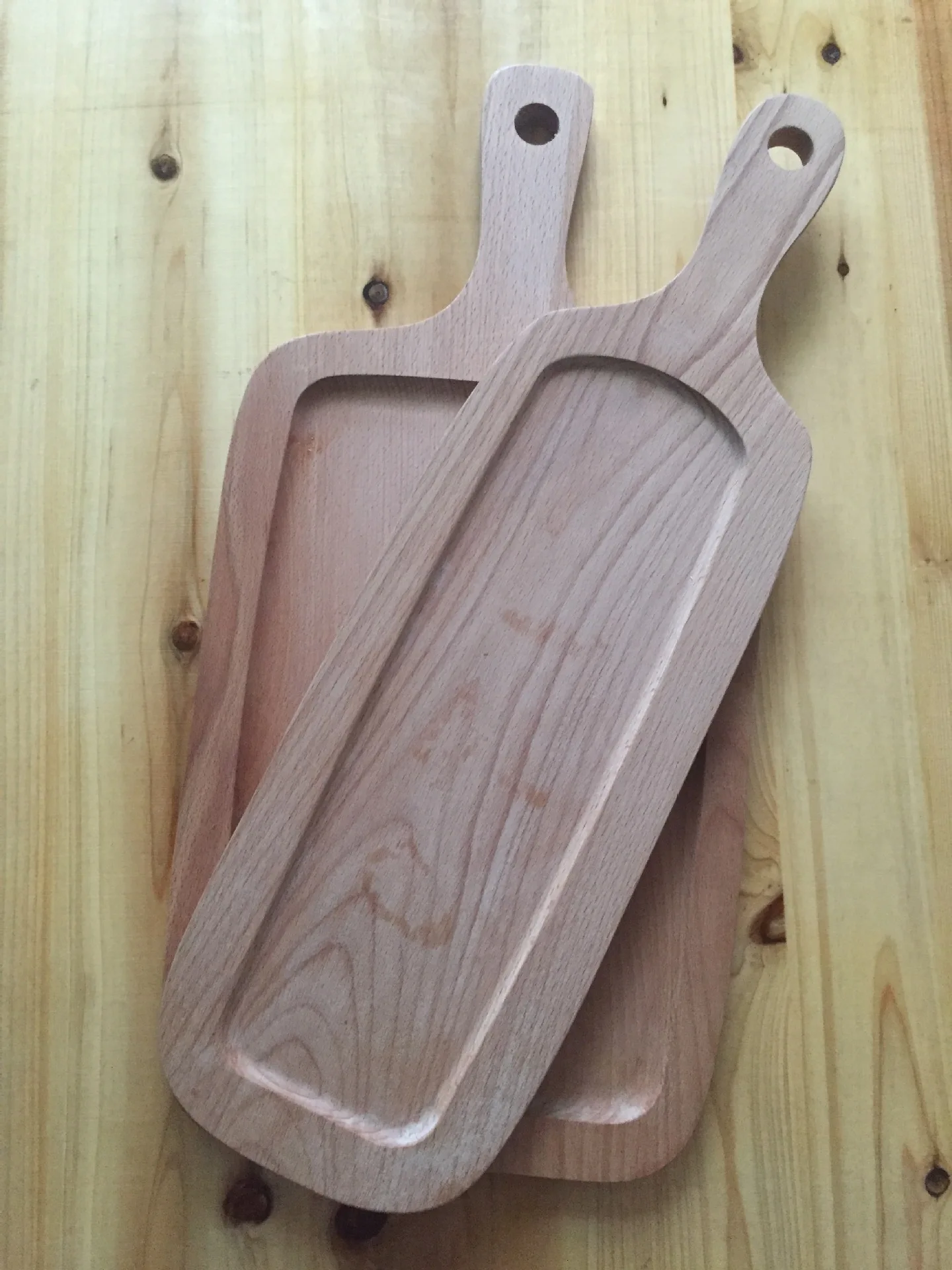 large wooden cutting board with handle