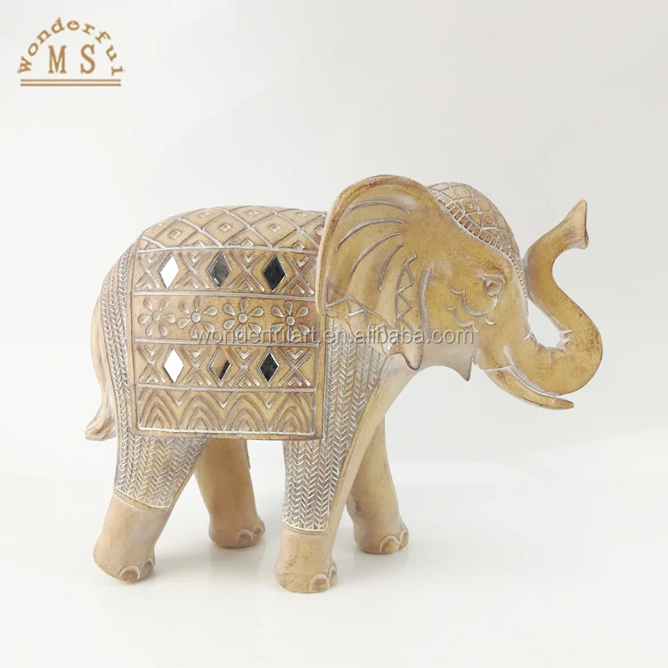 A shiny golden elephant statue dressed in ceremonial clothing symbolizes nobility glory and splendor Resin Craft for Homedecor